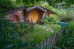Yellow Hobbit Hole with lots of Shrubbery